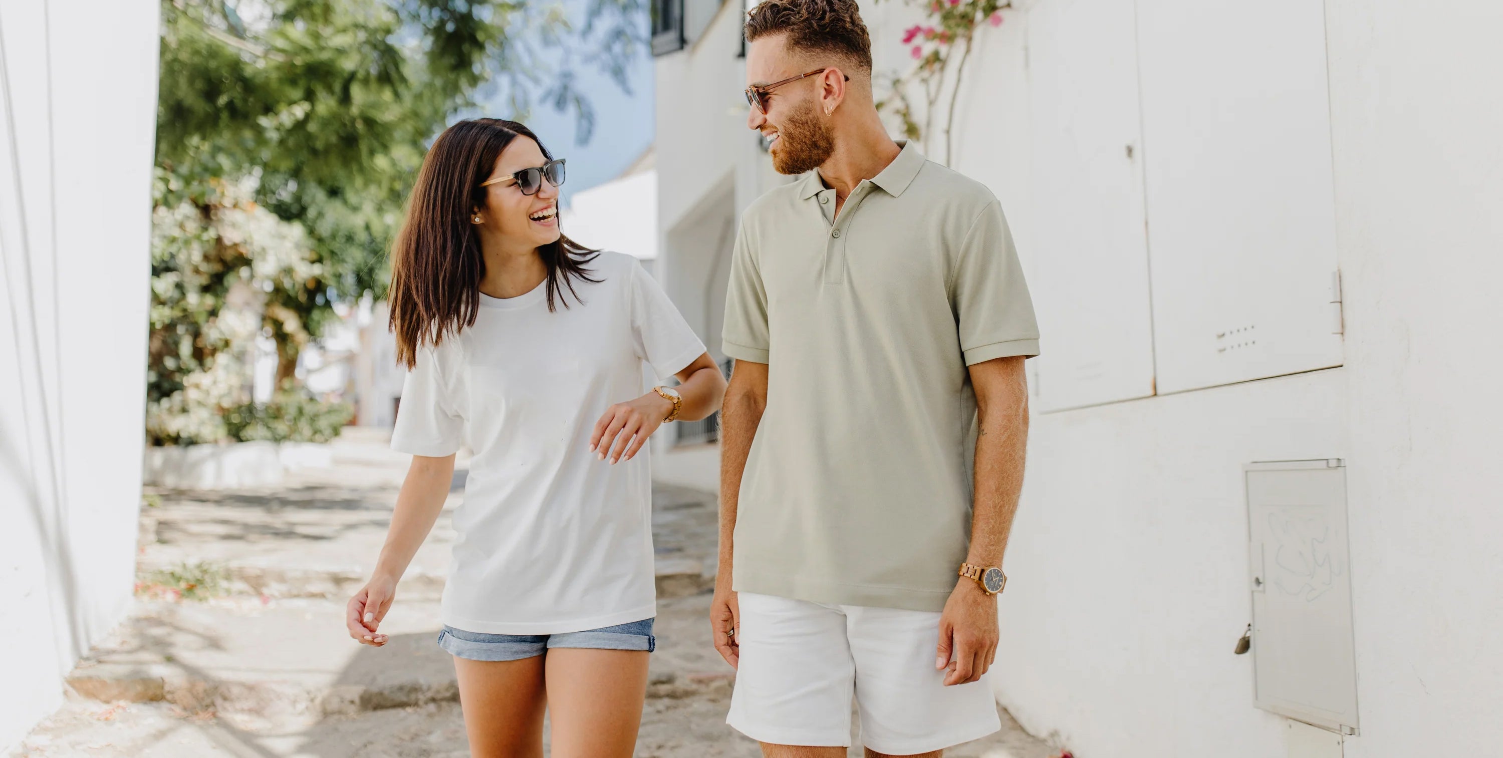a couple laughing while wearing forest wooden watches in the sun