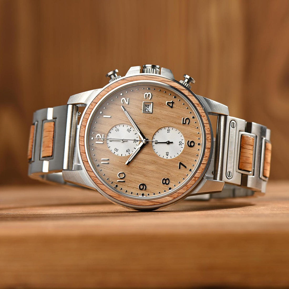 Barrel watch in whisky barrel oak with a stainless steel frame, on a wooden surface