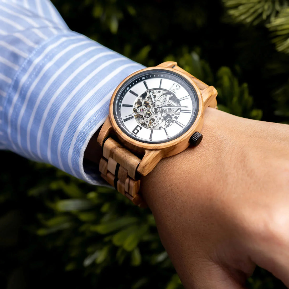 Woodhaven wooden watch worn on the wrist with a striped shirt cuff