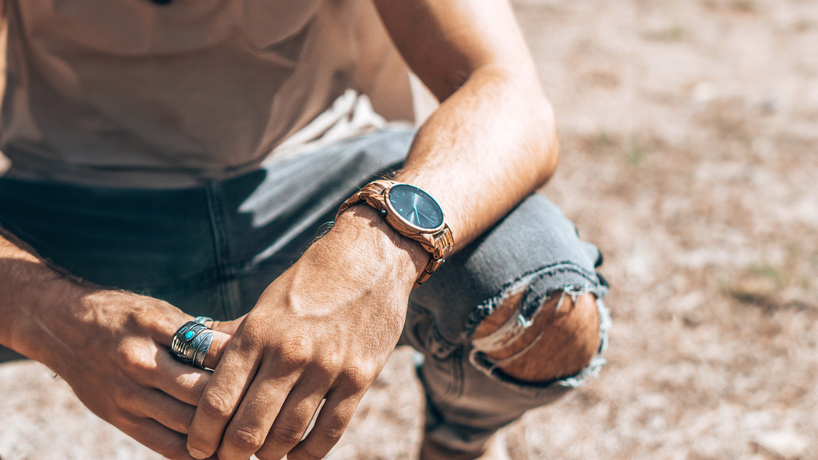 mani in blue jeans white top wearing a forest wooden watch made from Zebrawood