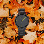 Umber black wood watch on autumn leaves