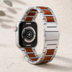 Wood and stainless-steel Apple Watch strap showing the rear sensor and butterfly clasp