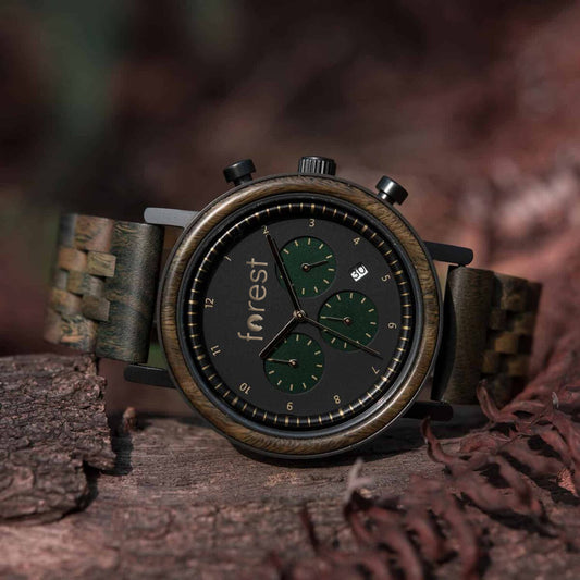 Hunter wooden mens watch on its side wid leafy background