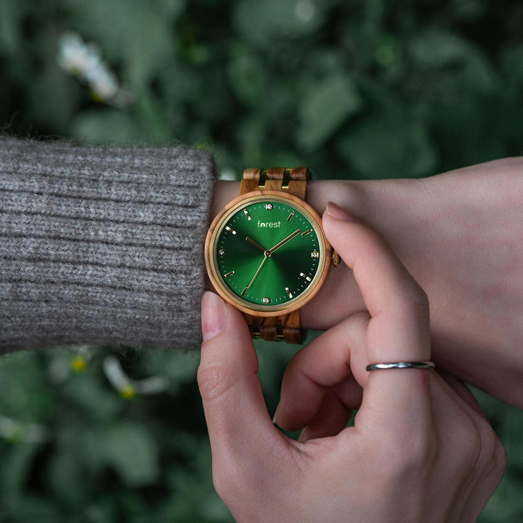 Forest wood watch IVY on a womans wrist while she frames the watch face with her other hand