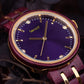 A close up of a womans gold and red wooden watch