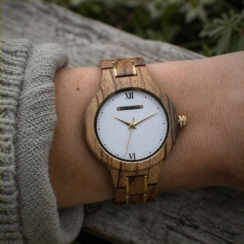 ZARA zebrawood women’s watch worn on the wrist, white dial with gold hands and Roman numerals