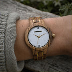 ZARA zebrawood women’s watch worn on the wrist, white dial with gold hands and Roman numerals