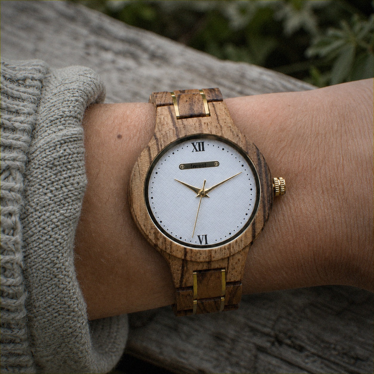 ZARA zebrawood women’s watch worn on the wrist, white dial with gold hands and Roman numerals
