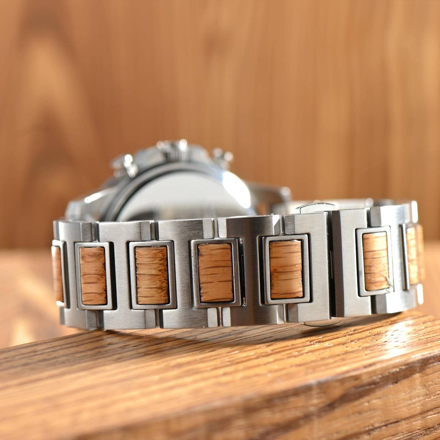 Back view of Barrel whiskey wood watch for men on a wooden table