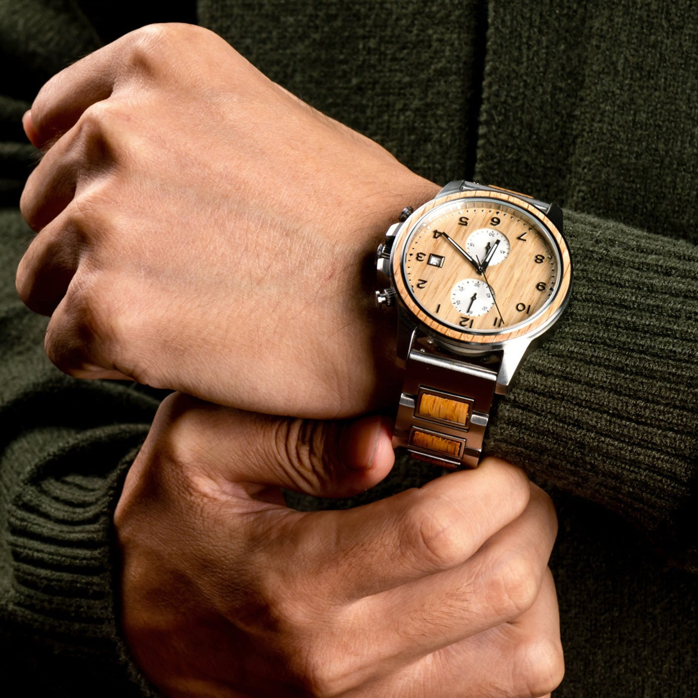 Close-up of man's hand touching the strap of Barrel whiskey wood watch