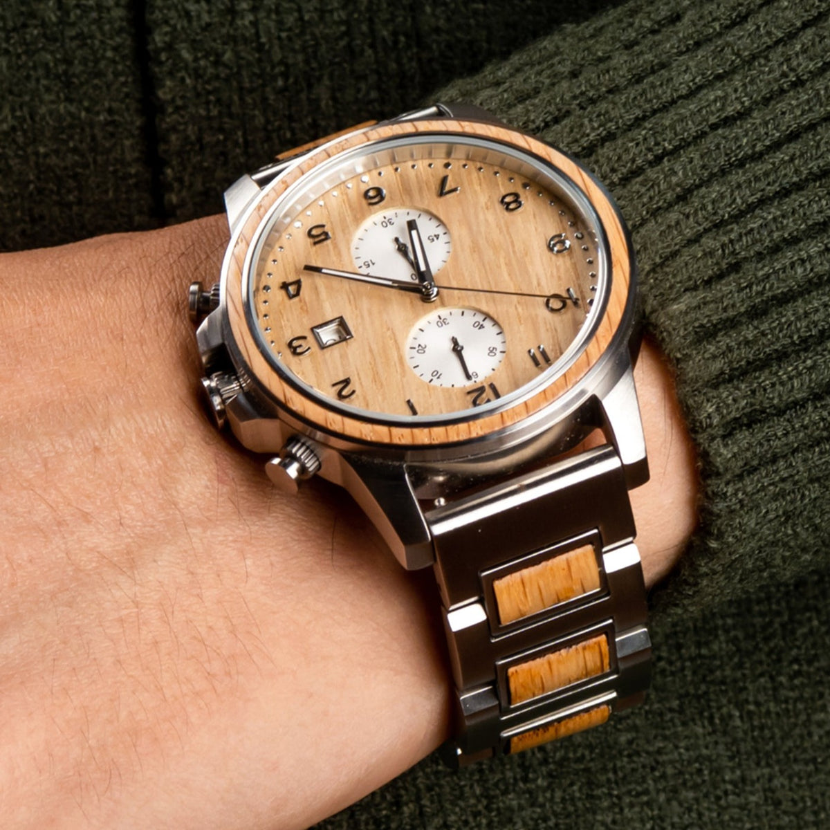 A close up of a man showcasing Barrel whiskey wood watch on his wrist