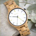 Dawn wooden watch, close view of the white dial and greeny yellow markers