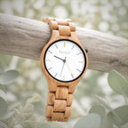 Dawn wooden watch hanging over a pale branch