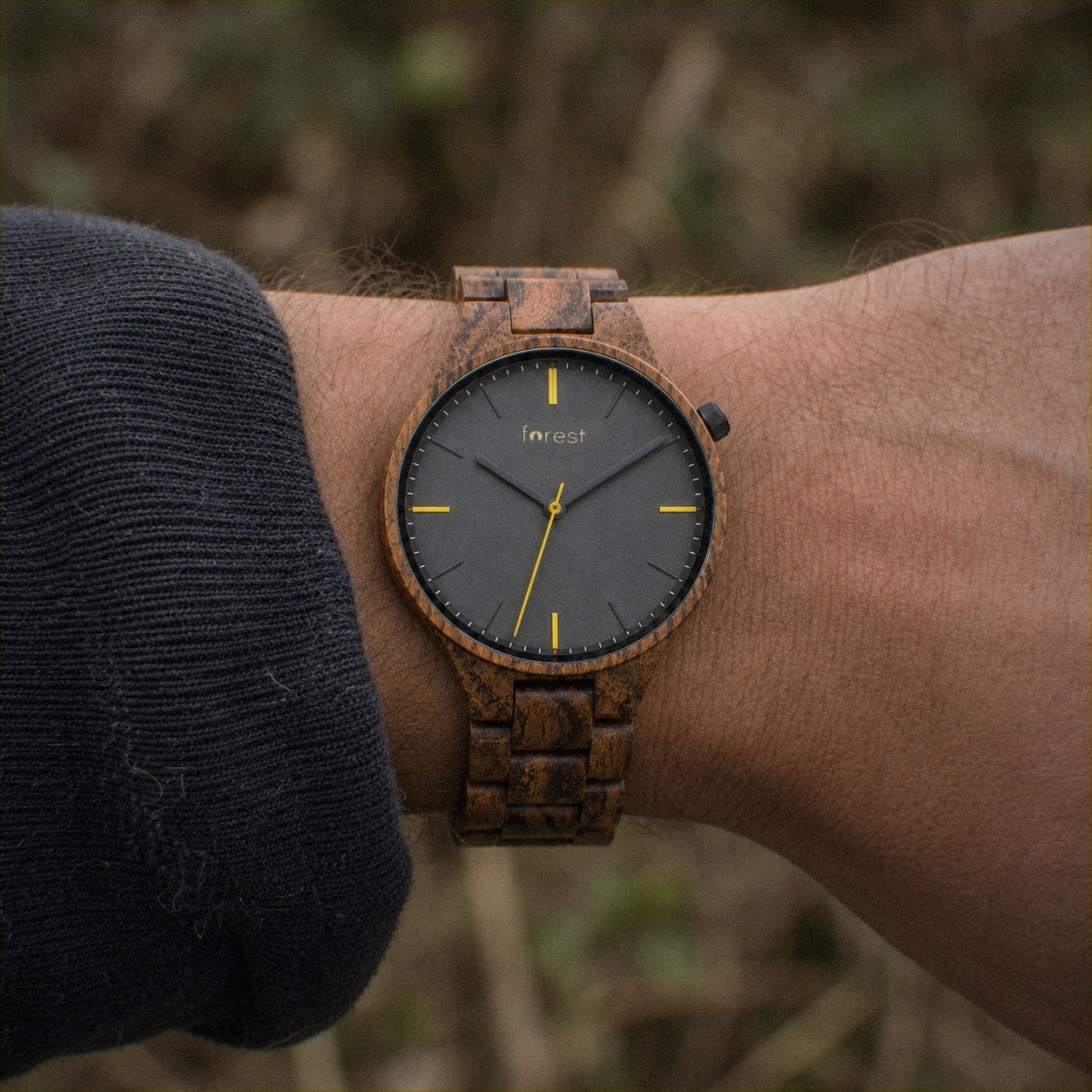 Dusk wooden watch worn on the wrist outdoors