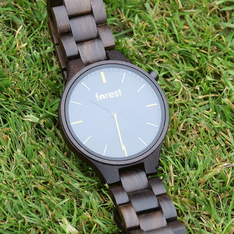 Umber black wooden watch on grass