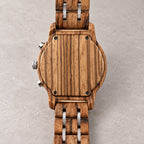Blank wooden case back of the Ember watch with four screws and wood-and-silver bracelet