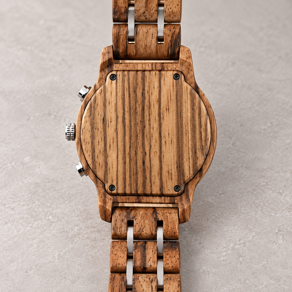 Blank wooden case back of the Ember watch with four screws and wood-and-silver bracelet