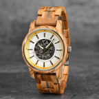 Gold/silver accent WOODHAVEN wooden watch standing upright, showing the full wooden band and clasp