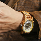 Gold/silver accent WOODHAVEN wooden watch worn on the wrist with a leather jacket