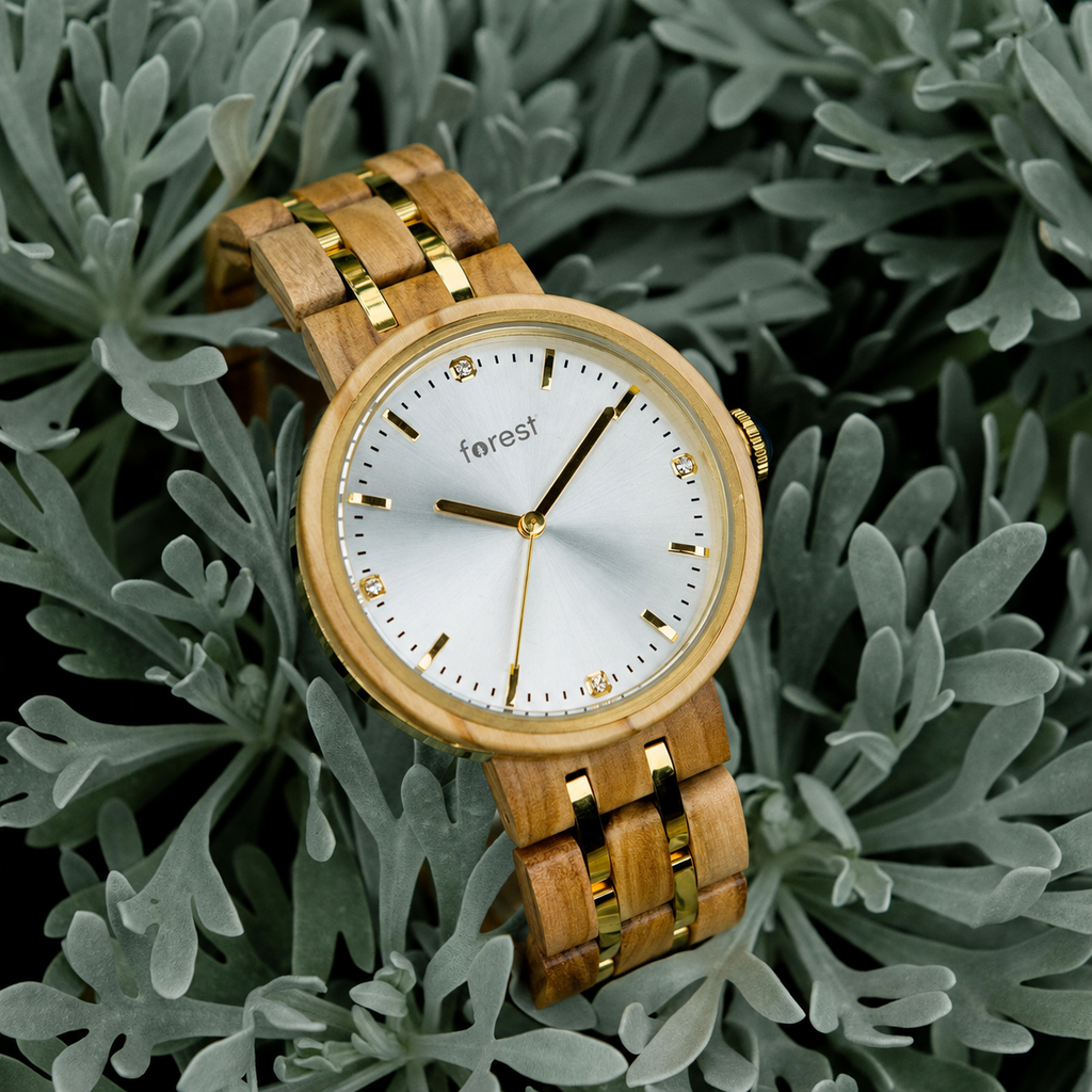 Victoria women's olivewood wooden watch at an angle on a leafy background