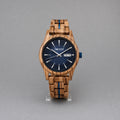Harbour men's zebrawood watch with navy dial, upright on a studio stand