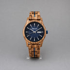 Harbour men's zebrawood watch with navy dial, upright on a studio stand