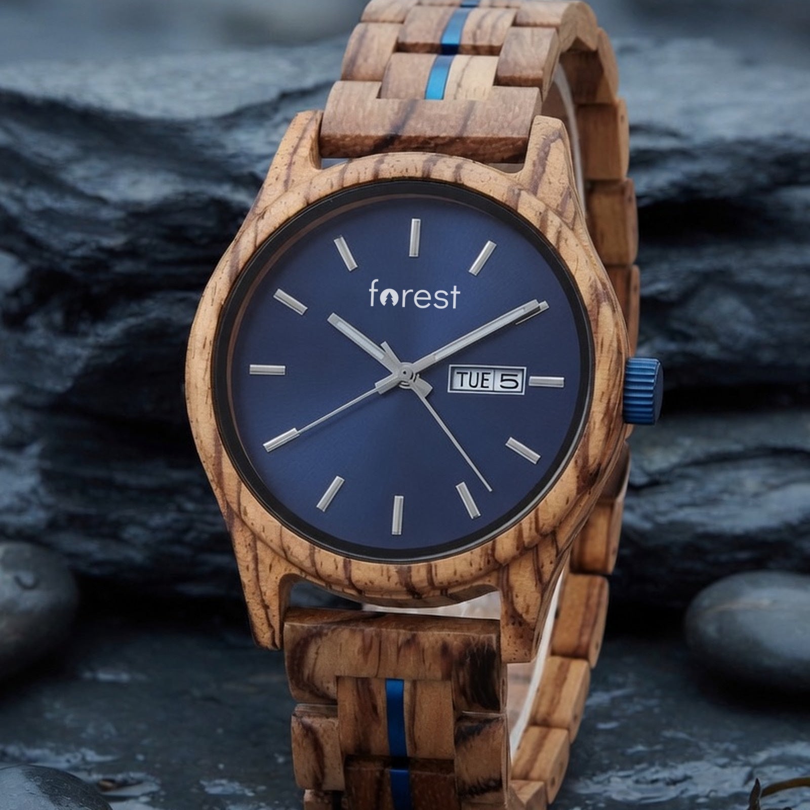 Harbour zebrawood watch with navy dial, standing upright on wet coastal slate, front view