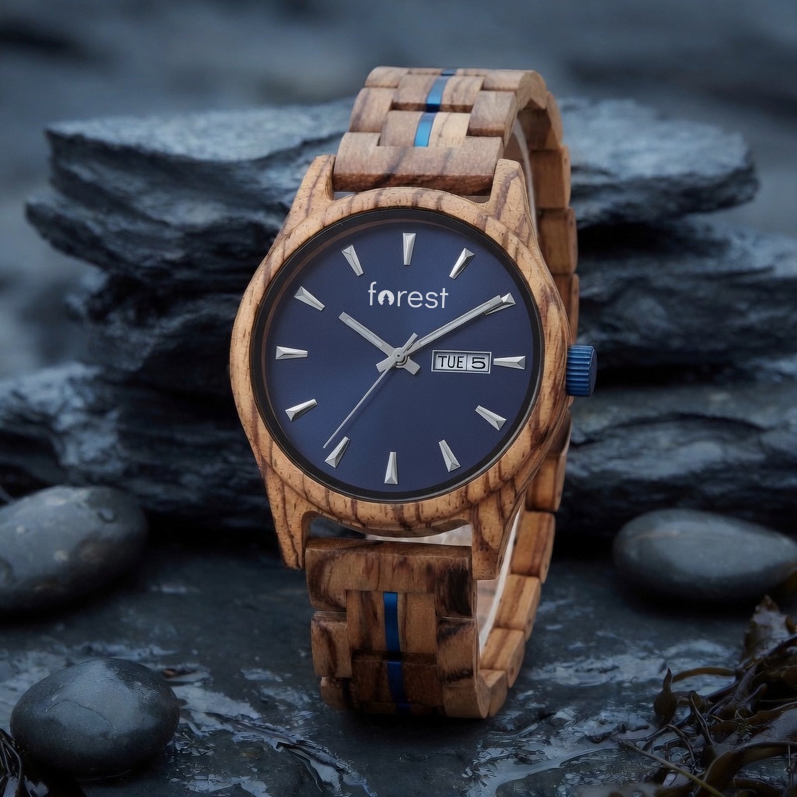 Harbour zebrawood watch with navy dial, low view on wet coastal slate, leaning back