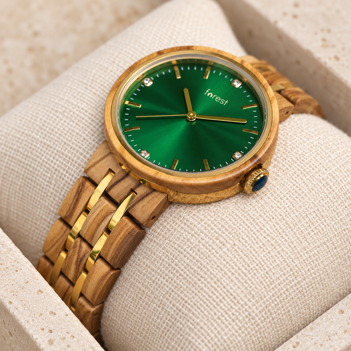 Close view of the Ivy emerald sunburst dial, gold hands and square crystal hour markers