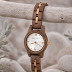 White dial Midnight wooden watch hanging from a driftwood branch