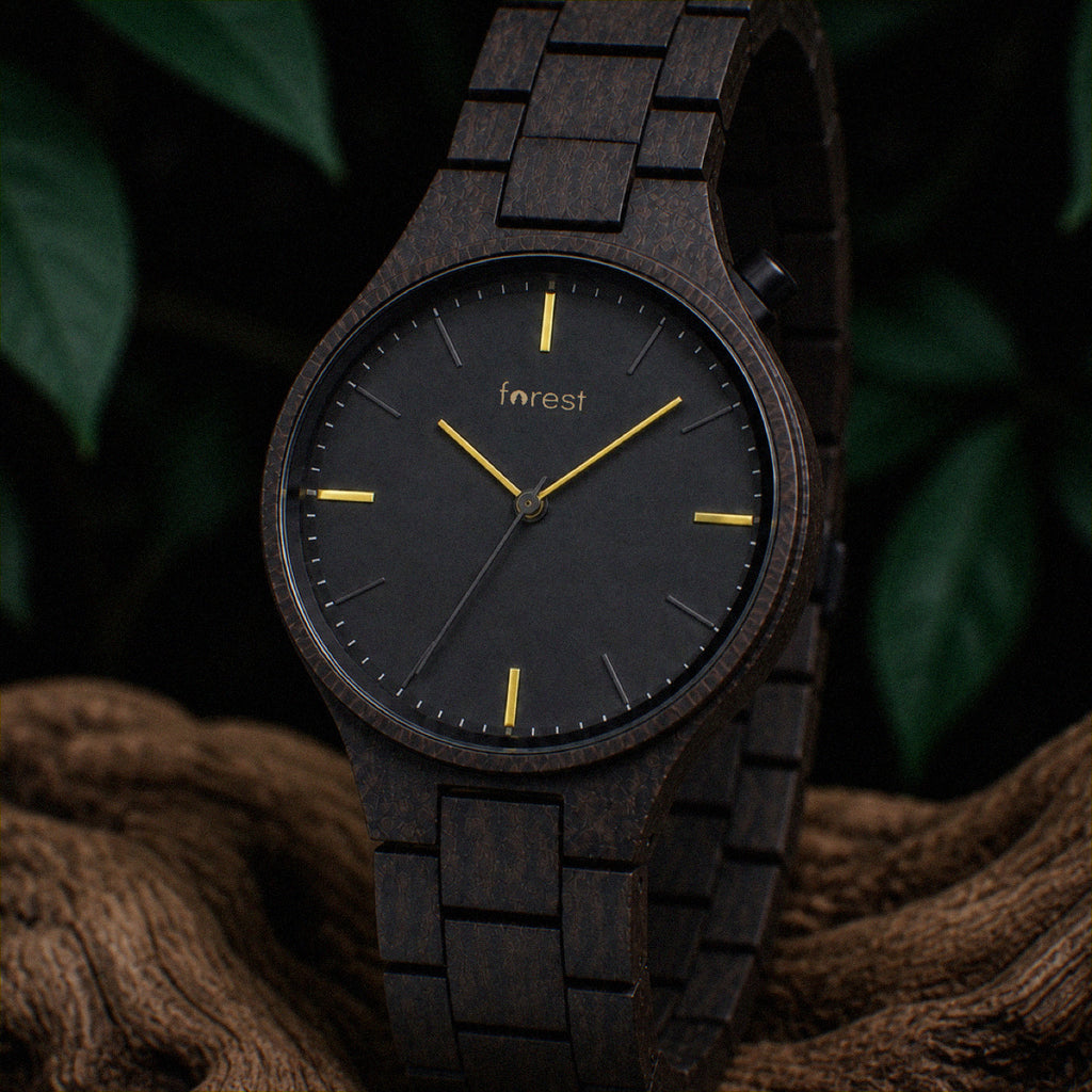 Nightfall wooden watch hanging over a driftwood branch