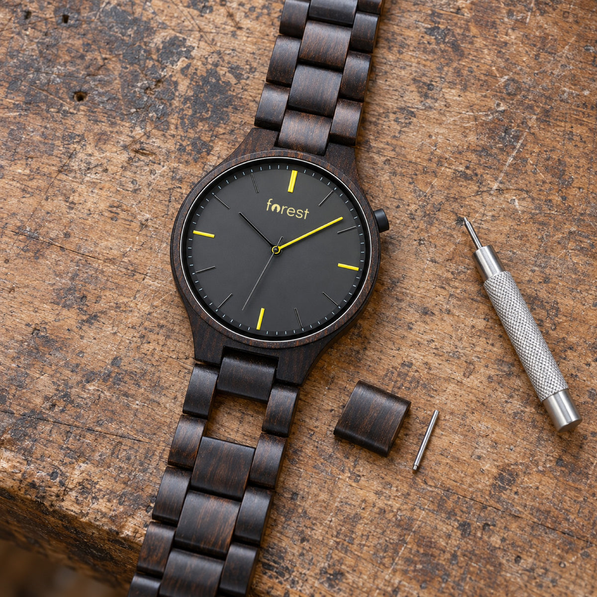 Nightfall ebony watch with its middle link removed and the link tool beside it