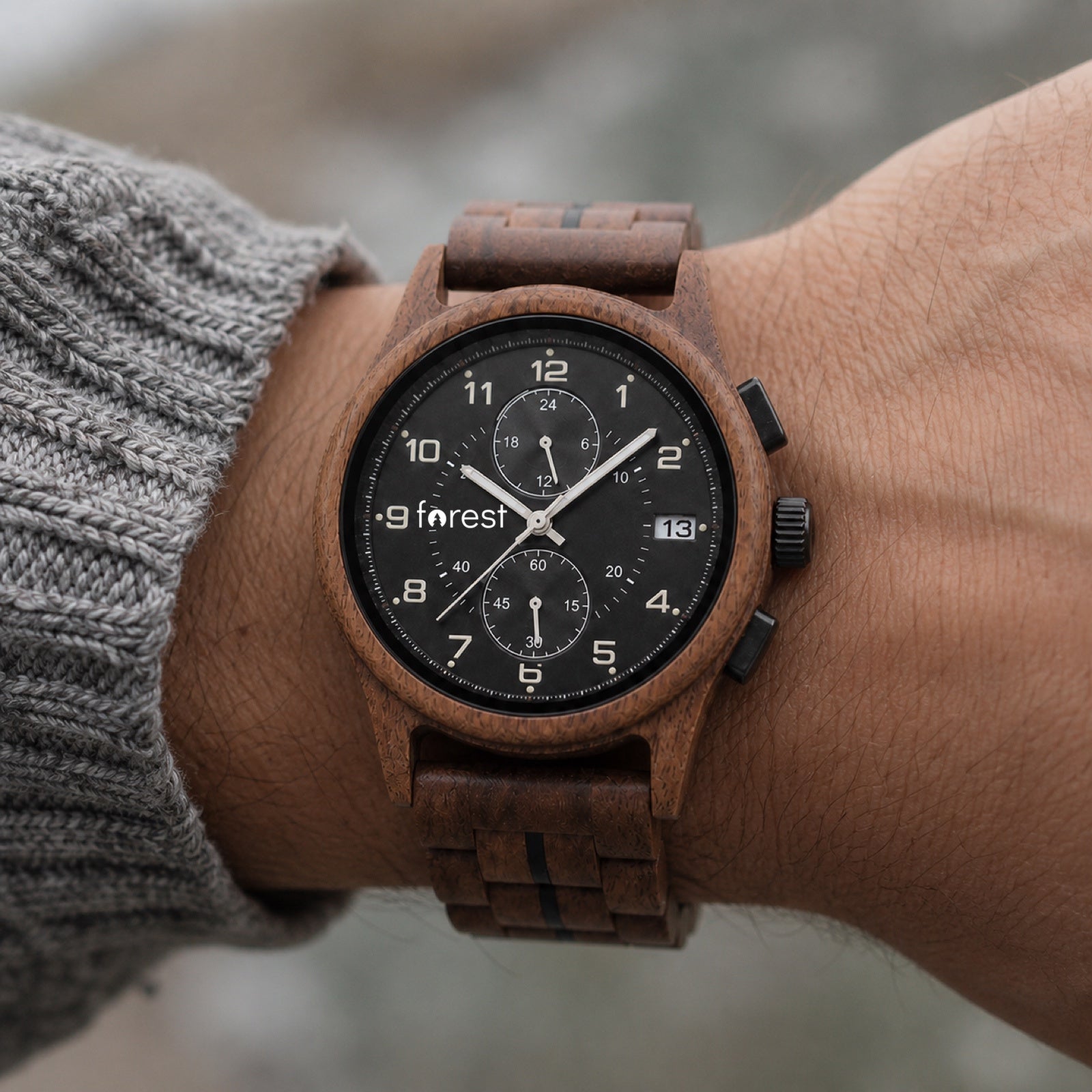 Raven wooden watch worn on a wrist in daylight
