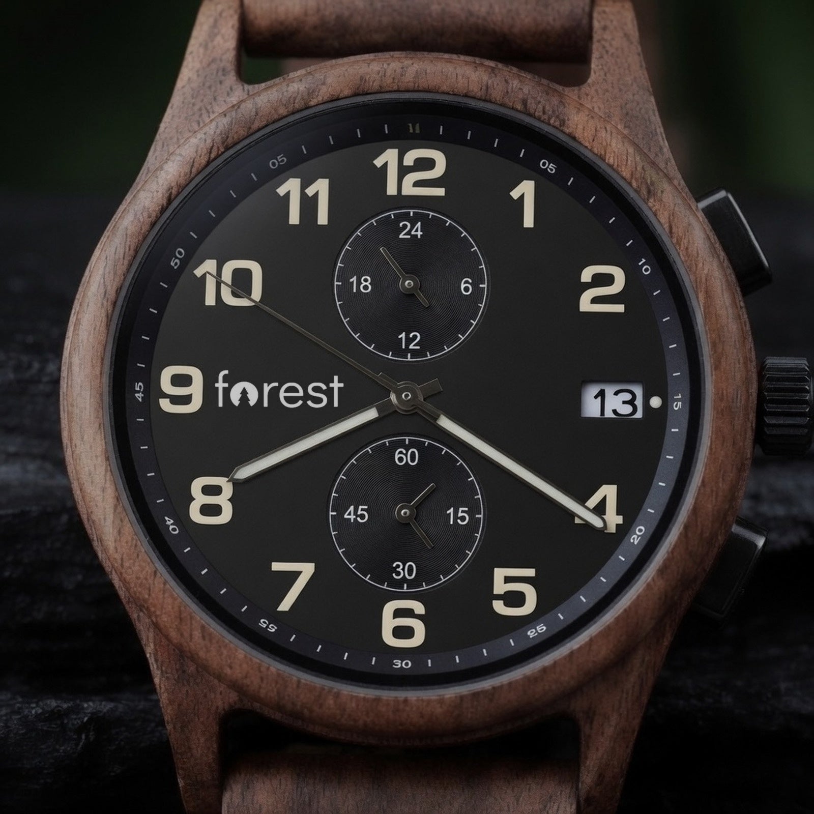 Raven walnut chronograph with black dial, close view of the dial on dark wet slate