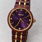 Close view of Royal’s purple sunburst dial, gold hands and crystal hour markers