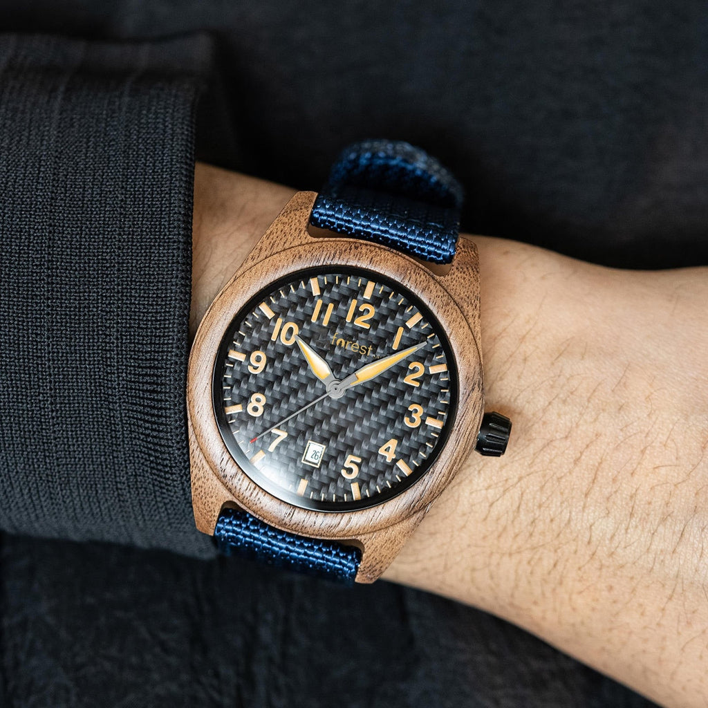 Scout wooden watch worn on the wrist below a dark sleeve