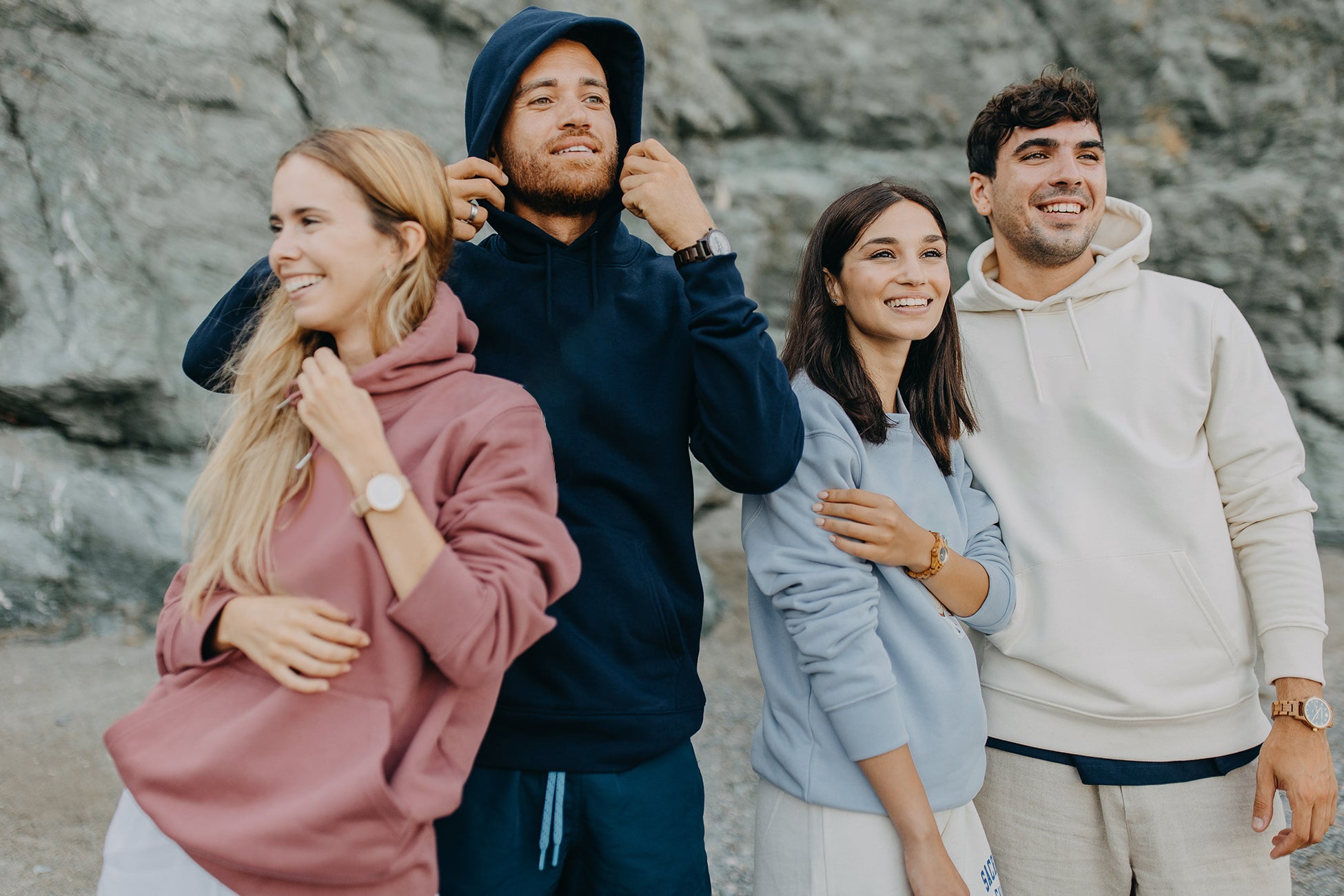Friends wearing wooden watches on UK beach