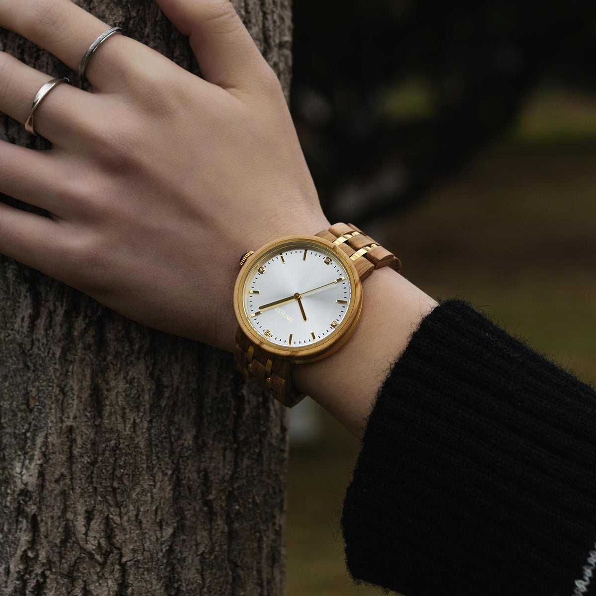 Forest watch Victoria on a womans watch as she touches a tree trunk