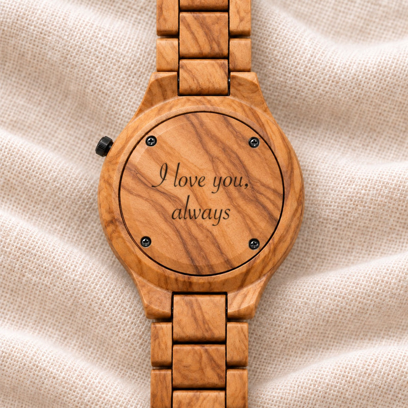 Dawn watch turned over, its olivewood back engraved with a message