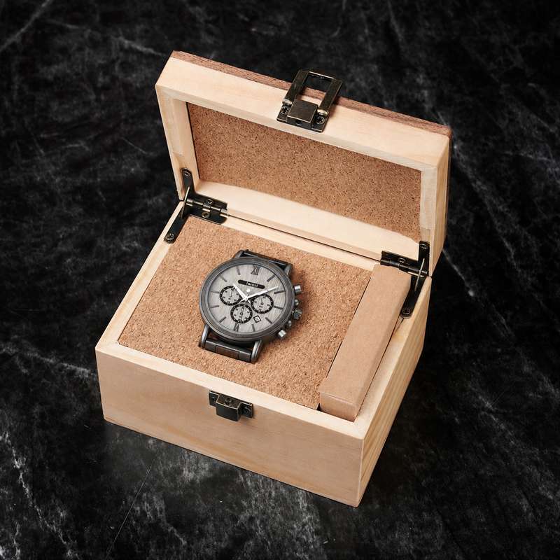 Flint wood and steel watch resting in its included pale wooden gift box