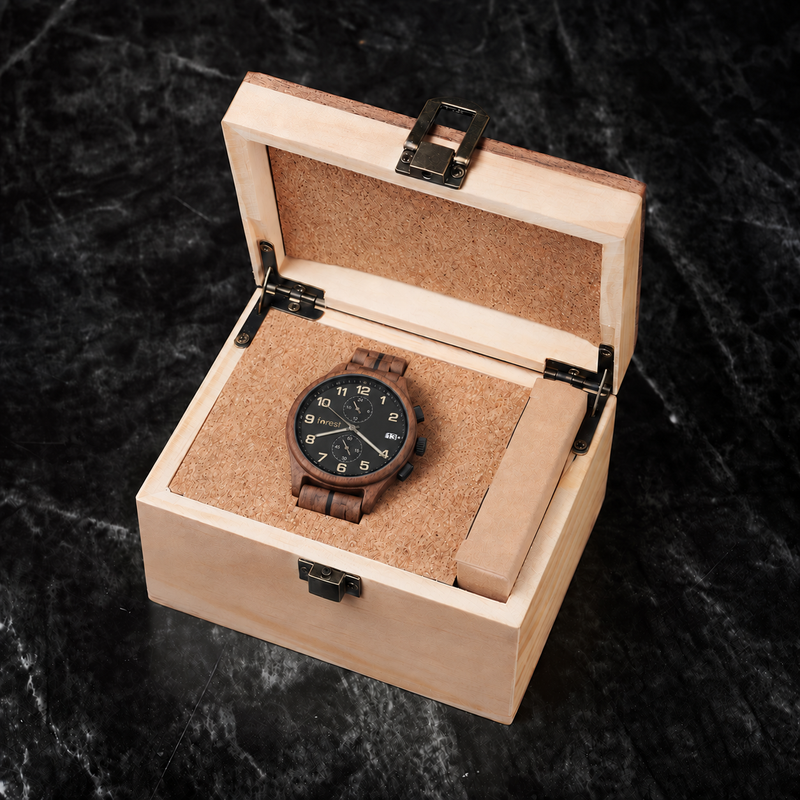 Raven walnut chronograph watch resting in its included pale wooden gift box